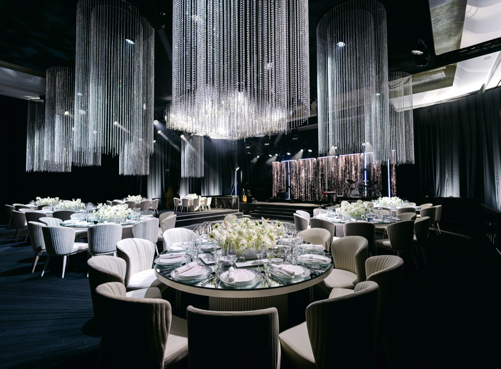 An intimate dining room set beneath shimmering crystal lights